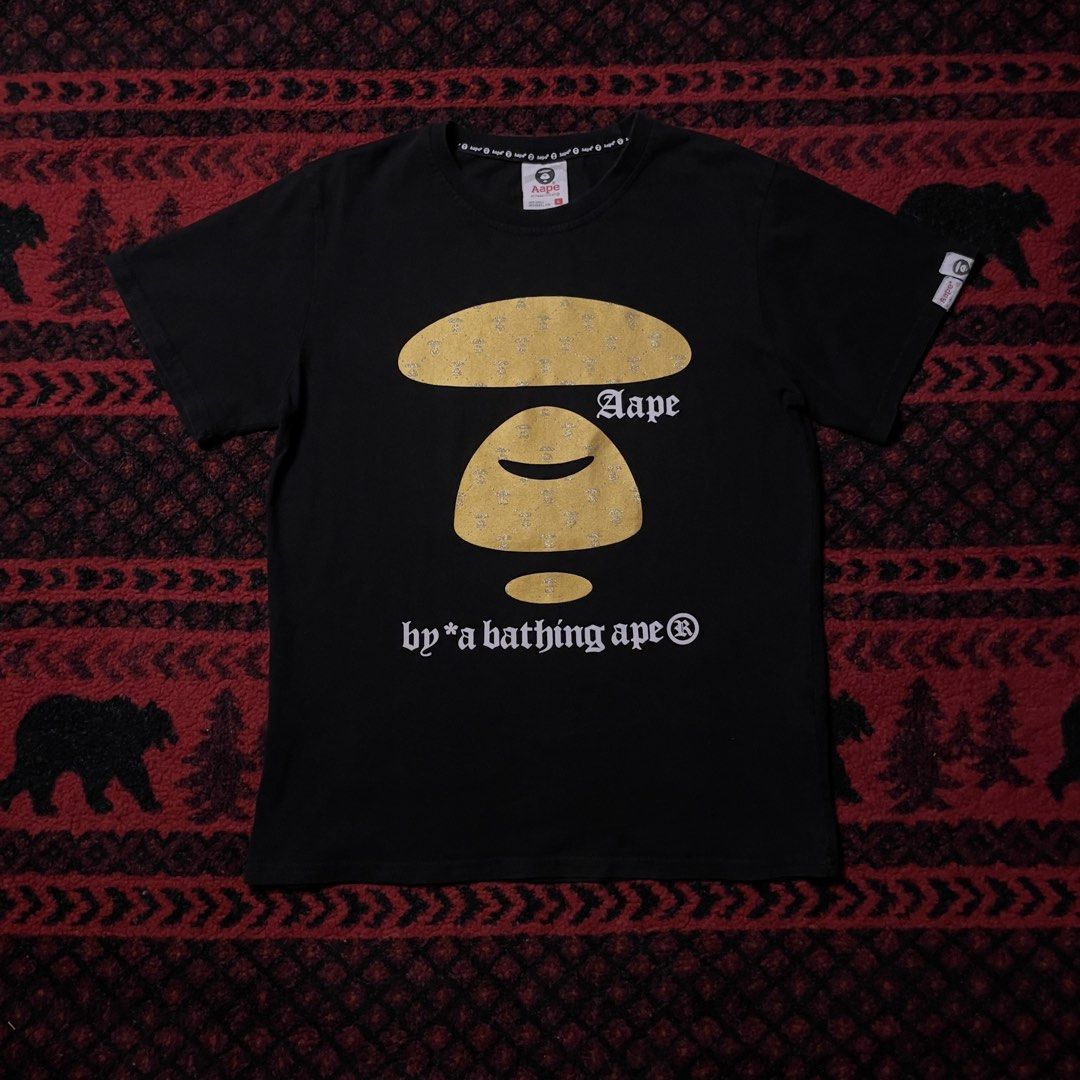 Aape Gold & Black Tshirt (Category: Tshirts & Polo Shirts ) located in Caloocan City. Submitted by piecesgarments (Listing ID 1463675240, Image 1). Description: Aape | Gold Black Tshirt (Next photos for detailed pictures and when worn) Size:small to medium Width:20" Length:26" Material Quality:cotton Issue:minimal crack on borders Condition:Good As New Model:5’7 Price:₱450 📝Reminder: All items are thrifted.Expect the condition of the item is use
