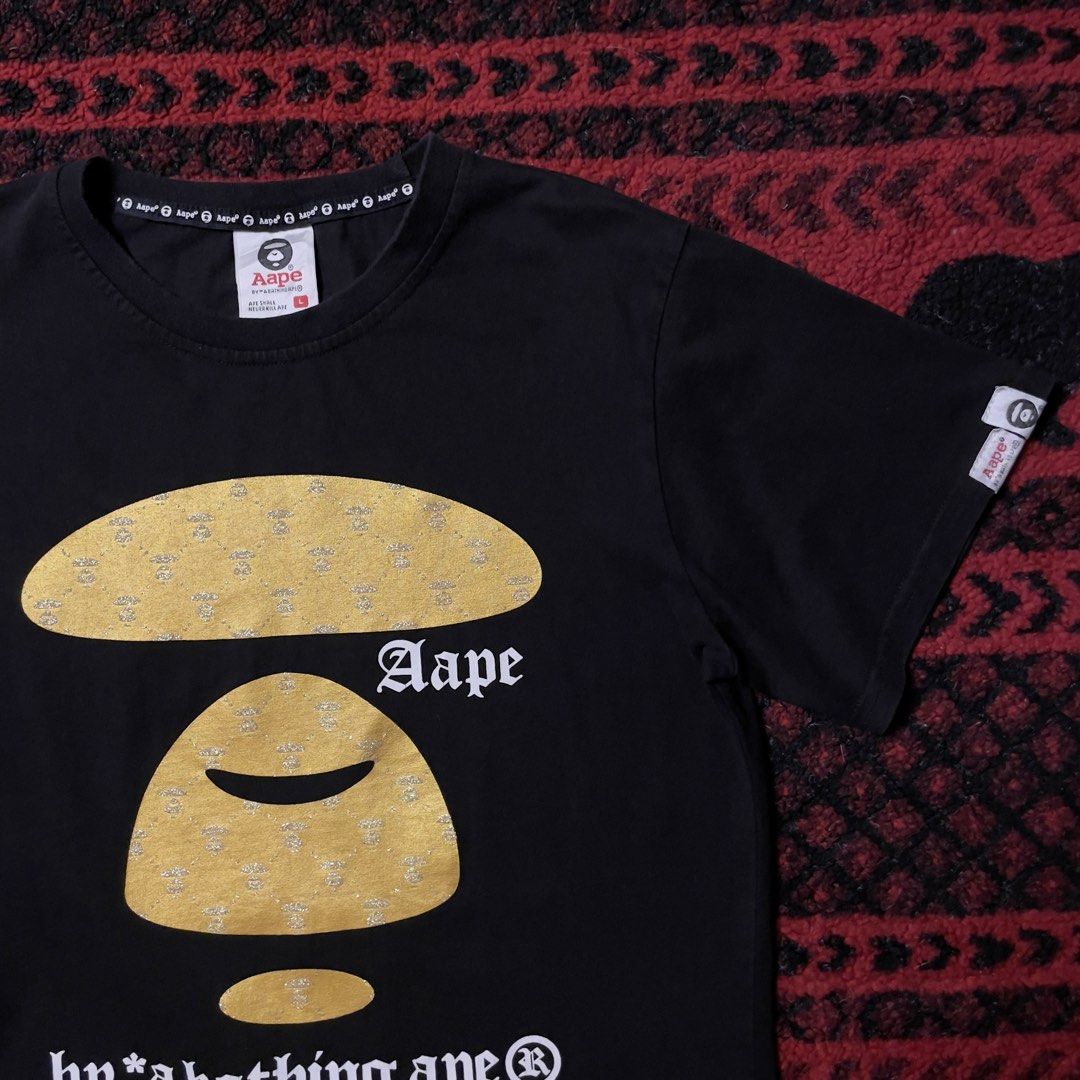 Aape Gold & Black Tshirt (Category: Tshirts & Polo Shirts ) located in Caloocan City. Submitted by piecesgarments (Listing ID 1463675240, Image 2). Description: Aape | Gold Black Tshirt (Next photos for detailed pictures and when worn) Size:small to medium Width:20" Length:26" Material Quality:cotton Issue:minimal crack on borders Condition:Good As New Model:5’7 Price:₱450 📝Reminder: All items are thrifted.Expect the condition of the item is use