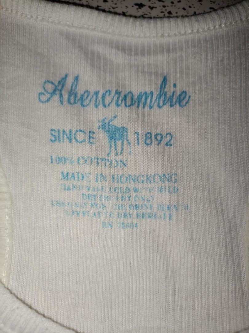 Abercrombie New York Graphic Tank Top (Category: Sleeveless) located in Caloocan City. Submitted by elle_f08 (Listing ID 1463667149, Image 2). Description: - White ribbed tank top from Abercrombie - Features '9A2 New York' graphic in blue on the front - Made of 100% cotton - Ideal for casual wear.