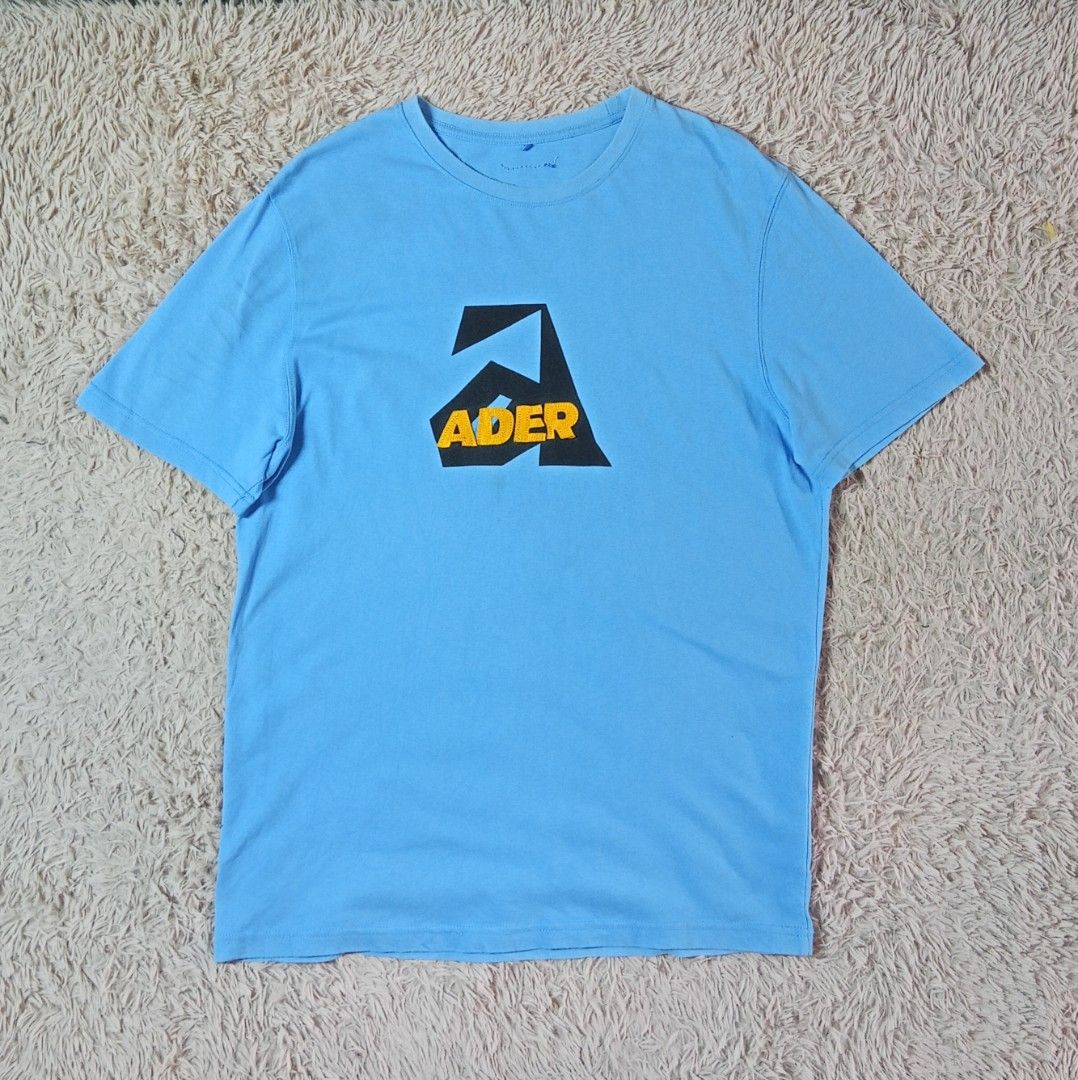 ADER Error Blue Graphic T-Shirt (Category: Tshirts & Polo Shirts ) located in Lucban. Submitted by aeronroyyy (Listing ID 1463625017, Image 1). Description: - ADER Error t-shirt in light blue - Features signature 'A' logo graphic on the front - Made in Korea - High-quality cotton for comfort - Perfect for simple, stylish everyday wear.