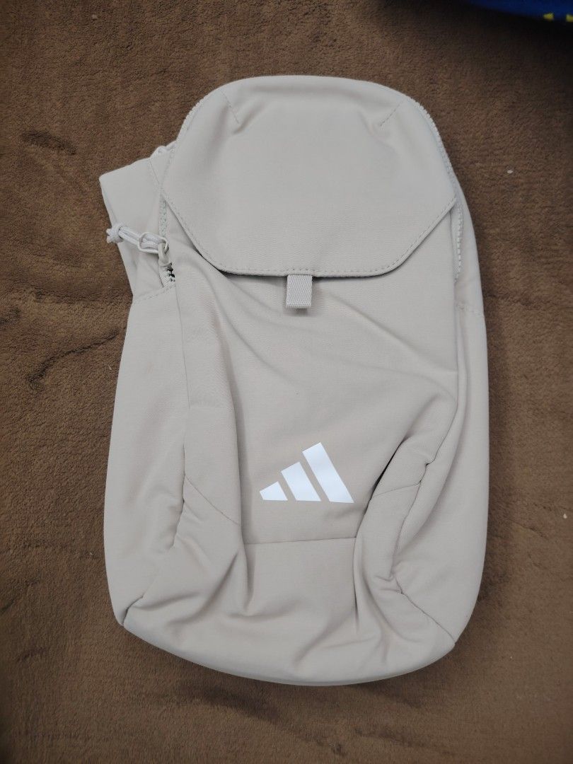 Adidas Beige Sling Bag (Category: Sling Bags) located in Manila. Submitted by cmmirandilla (Listing ID 1463566676, Image 1). Description: Adidas Crossbody Slingbag! Imported from US! For only P1499 We have 2 on stock! Available for pick-up and delivery (Free delivery)! Marikina/Cainta area.