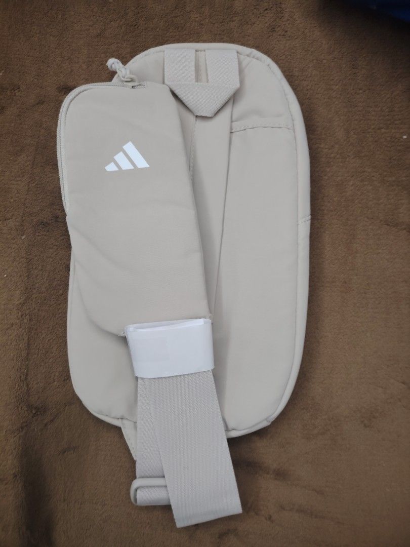 Adidas Beige Sling Bag (Category: Sling Bags) located in Manila. Submitted by cmmirandilla (Listing ID 1463566676, Image 2). Description: Adidas Crossbody Slingbag! Imported from US! For only P1499 We have 2 on stock! Available for pick-up and delivery (Free delivery)! Marikina/Cainta area.