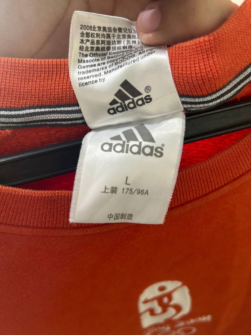 Adidas Beijing 2008 Olympics Crewneck (Category: Coats, Jackets and Outerwear) located in Taguig. Submitted by MoveQuickly (Listing ID 1463628247, Image 2). Description: - Orange Adidas crewneck sweatshirt - Size: L (28L x 18W) - Features Beijing 2008 Olympics logo and mascot - Classic Adidas three stripes on sleeves - Ideal for Adidas and Olympics enthusiasts - Comfortable and stylish.
