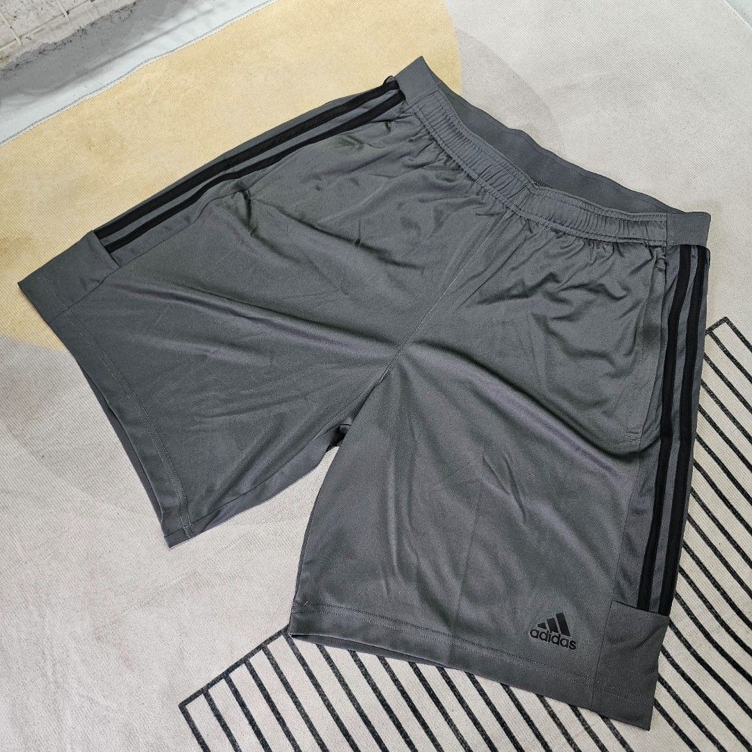 Adidas Gray Shorts (Category: Shorts) located in Baguio. Submitted by kayeonlineshop (Listing ID 1463621888, Image 1). Description: gray Adidas athletic shorts featuring classic black side stripes and the brand's logo on the lower hem w32-40 L20.5 h29.