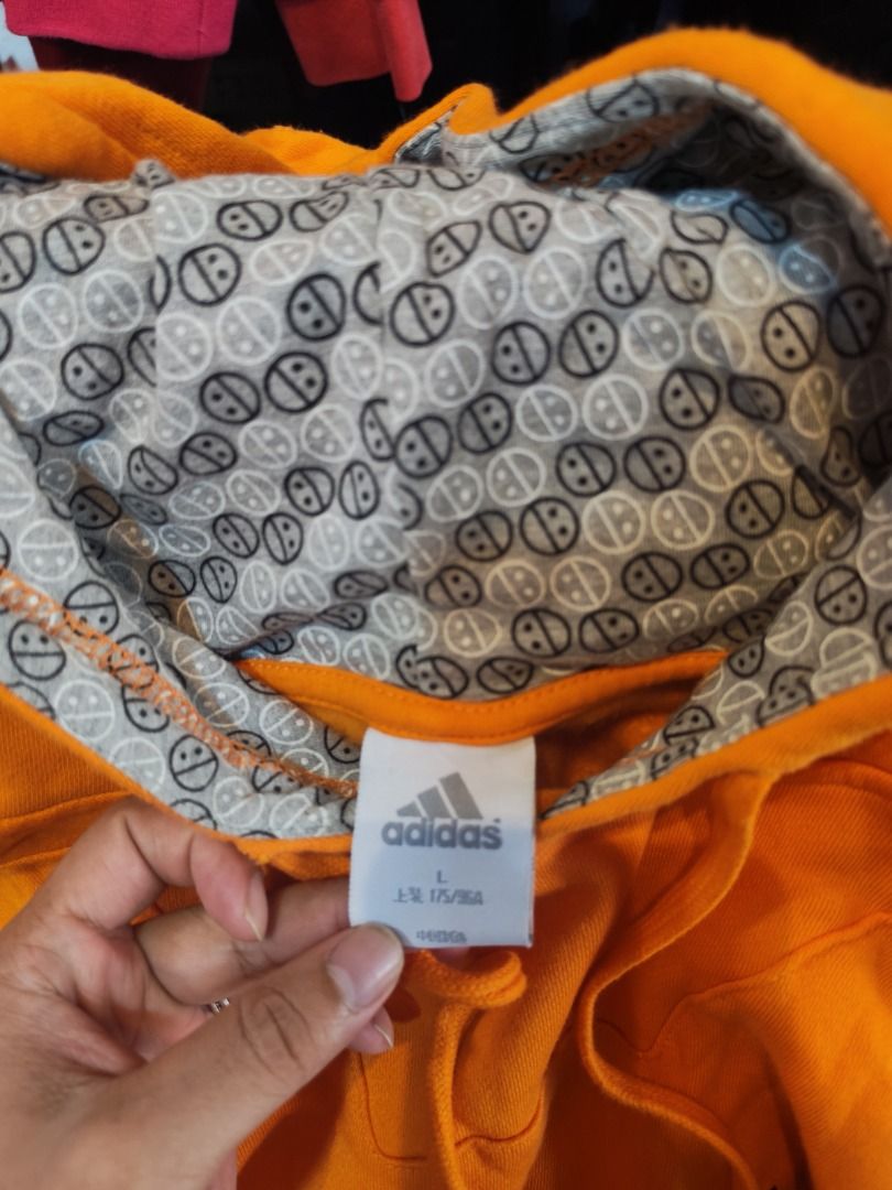 Adidas Orange Hoodie Pullover Size L (Category: Coats, Jackets and Outerwear) located in Quezon City. Submitted by drift_and_vibe_thrift (Listing ID 1463591037, Image 3). Description: - Orange Adidas hoodie - Size L - Features a cool patterned lining inside the hood - Front kangaroo pocket - Great for casual wear.