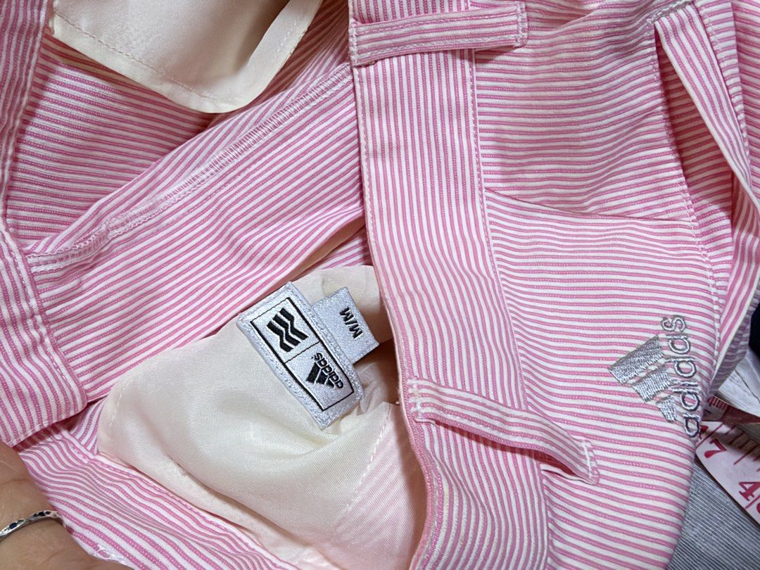 Adidas Pink Striped Golf Shorts (Category: Shorts) located in Paete. Submitted by skydruemadison (Listing ID 1463687334, Image 3). Description: - Adidas golf shorts - Color: Pink with white pinstripes - Size: Medium (M) - Closure: Button and zip fly - Pockets: Two front, two back - Versatile: Ideal for golf or casual outings - Fit: Comfortable.