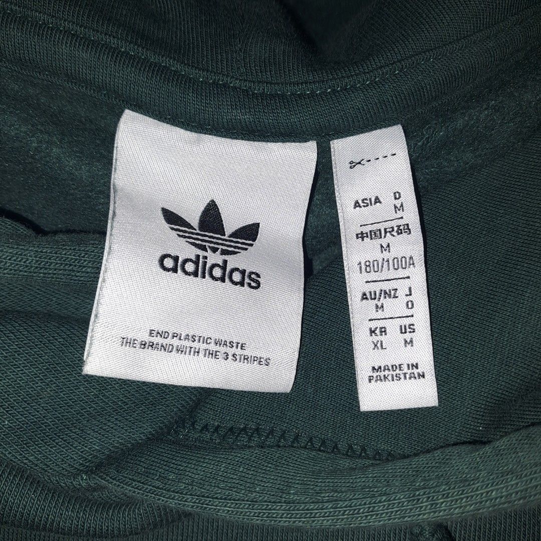 Adidas Trefoil Essentials Hoodie (Category: Coats, Jackets and Outerwear) located in Manila. Submitted by free_joe (Listing ID 1463582962, Image 2). Description: - Authentic - Dark Green - Medium - MOD: JNT - MOP: Gcash.