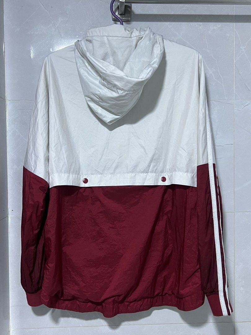 Adidas Windbreaker Jacket White Burgundy (Category: Coats, Jackets and Outerwear) located in Manila. Submitted by jj0451315 (Listing ID 1463632946, Image 2). Description: - Adidas Jacket - Color: White and Burgundy - Classic three stripes on sleeves - Hooded design with full zip closure - Lightweight material, ideal for windy days or light rain - Two side pockets - Versatile for sports or casual wear.