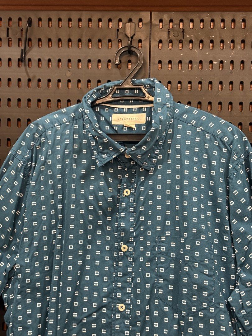 Aeropostale Blue Short Sleeve Button Up Shirt (Category: Tshirts & Polo Shirts ) located in San Fernando. Submitted by archvst.selects (Listing ID 1463669103, Image 2). Description: - Aeropostale blue short sleeve shirt - All-over small white square pattern - Button-up front with a collar - Chest pocket - Ideal for casual wear and easy styling Note: Item are personal preloved. Used once. Best fit for 168cm or 5”7.