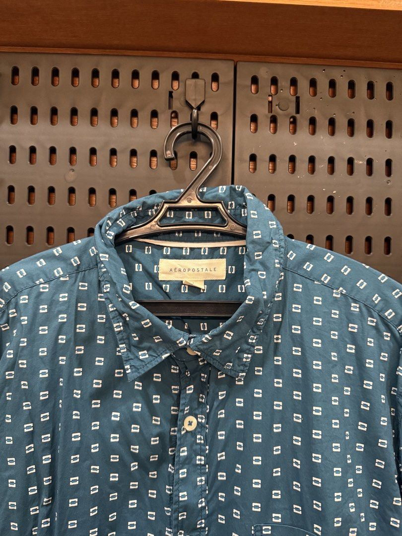 Aeropostale Blue Short Sleeve Button Up Shirt (Category: Tshirts & Polo Shirts ) located in San Fernando. Submitted by archvst.selects (Listing ID 1463669103, Image 3). Description: - Aeropostale blue short sleeve shirt - All-over small white square pattern - Button-up front with a collar - Chest pocket - Ideal for casual wear and easy styling Note: Item are personal preloved. Used once. Best fit for 168cm or 5”7.