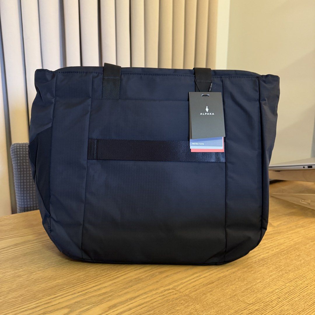 Alpaka Metro Tote (Category: Tote Bags) located in Pasig City. Submitted by mon.alcantara (Listing ID 1463615495, Image 2). Description: - Alpaka Metro Tote Bag in Black - Weatherproof fabrics for durability - Soft-touch fleece-lined sleeve fits up to 16" MacBook Pro - Smooth YKK zippers with DWR coating - Convenient magnetic key tether - External side pocket for umbrella or water bottle - Dimensions: 39cm (H) x 35cm (W) x 12cm (D) -Brandnew, sti