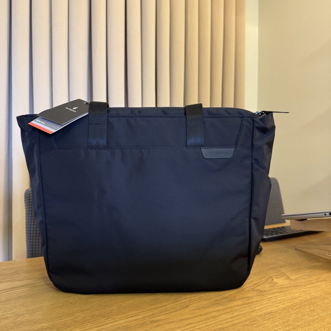 Alpaka Metro Tote (Category: Tote Bags) located in Pasig City. Submitted by mon.alcantara (Listing ID 1463615495, Image 1). Description: - Alpaka Metro Tote Bag in Black - Weatherproof fabrics for durability - Soft-touch fleece-lined sleeve fits up to 16" MacBook Pro - Smooth YKK zippers with DWR coating - Convenient magnetic key tether - External side pocket for umbrella or water bottle - Dimensions: 39cm (H) x 35cm (W) x 12cm (D) -Brandnew, sti