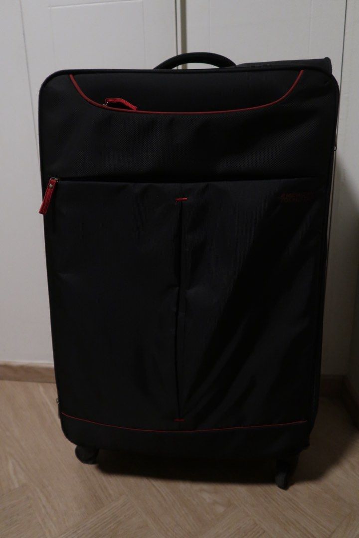 American Tourister Black Soft Shell Luggage Large (Category: Luggage) located in Pasig City. Submitted by dcvirata (Listing ID 1463680657, Image 1). Description: - Large black American Tourister suitcase - Red trim and bright red interior - Smoothly functioning zippers - Issues: wheels need replacement, lock works but it’s not smooth Dimensions: - Length 46cm - Height 78cm - Width 27cm.