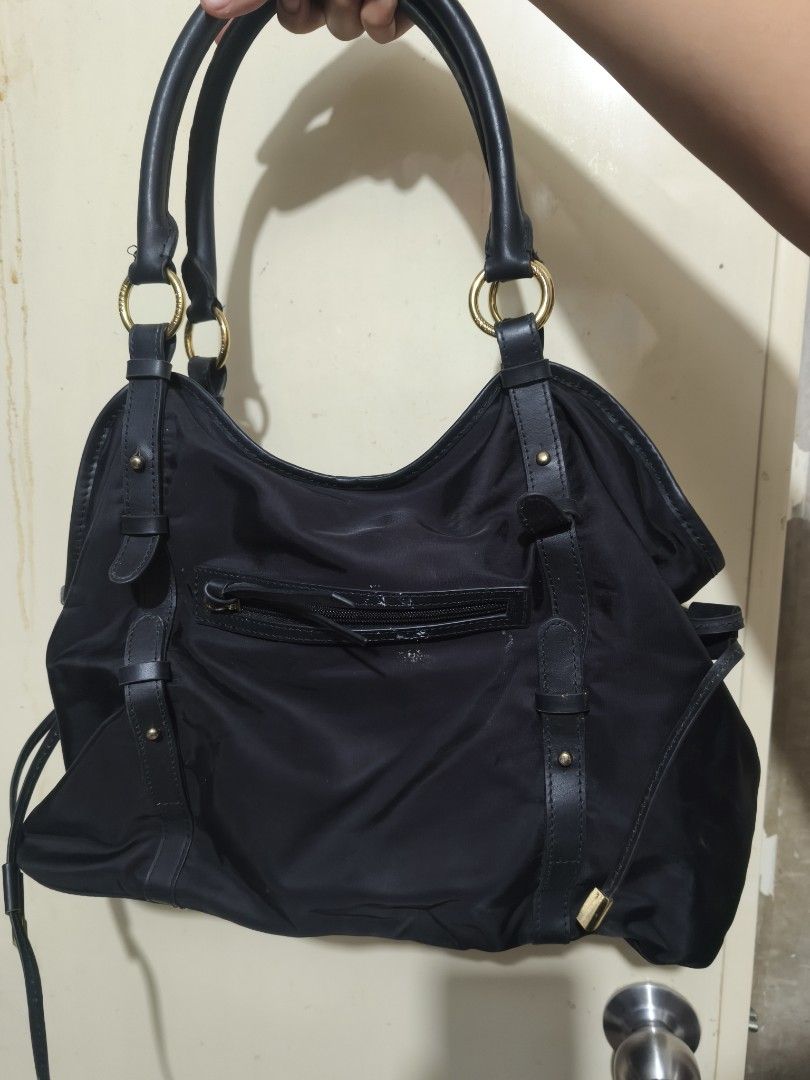 Anna Sui Black Nylon Leather Trim Shoulder Bag (Category: Shoulder Bags) located in Plaridel. Submitted by julleyuuuh (Listing ID 1463591775, Image 3). Description: - Brand: Anna Sui - Color: Black - Material: Nylon with leather trim - Hardware: Gold details - Interior: Purple floral lining - Closure: Top zipper - Features: Spacious, ideal for everyday use.