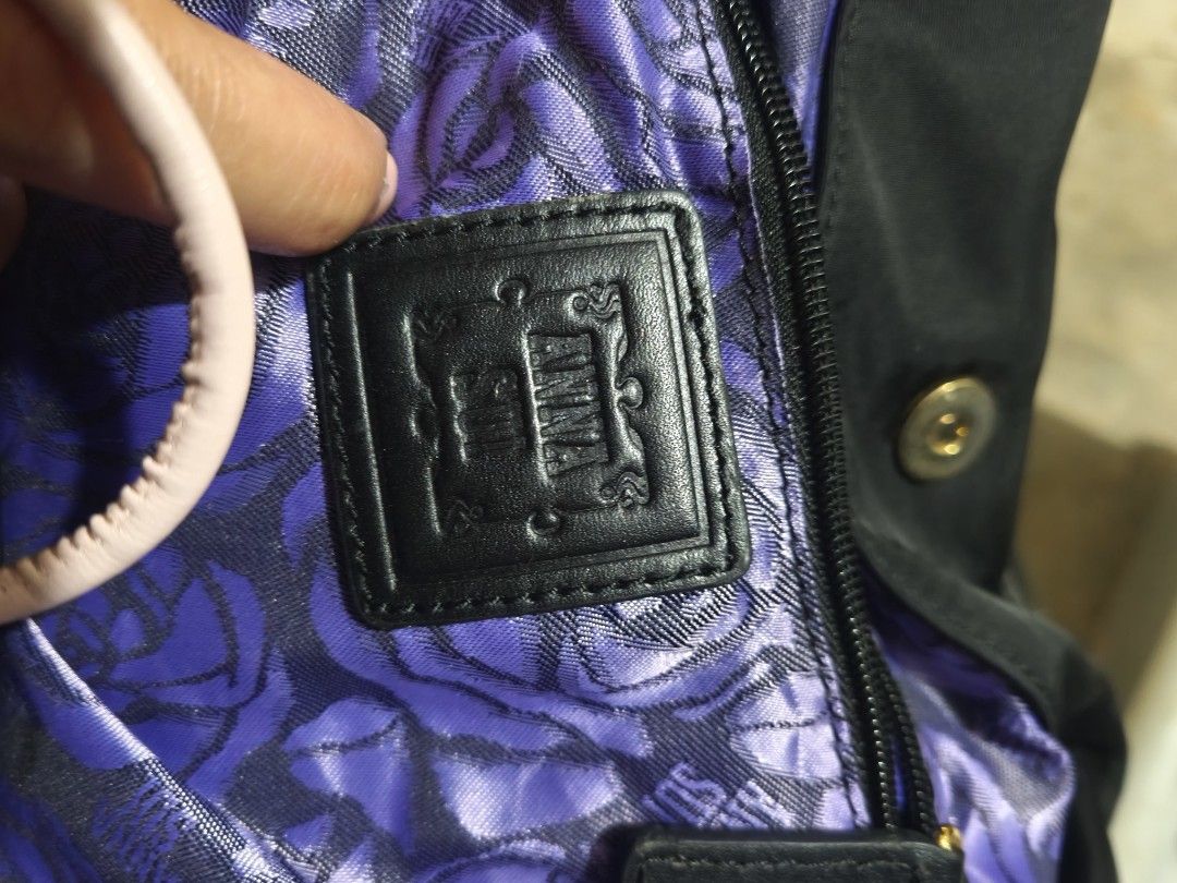 Anna Sui Black Nylon Leather Trim Shoulder Bag (Category: Shoulder Bags) located in Plaridel. Submitted by julleyuuuh (Listing ID 1463591775, Image 2). Description: - Brand: Anna Sui - Color: Black - Material: Nylon with leather trim - Hardware: Gold details - Interior: Purple floral lining - Closure: Top zipper - Features: Spacious, ideal for everyday use.