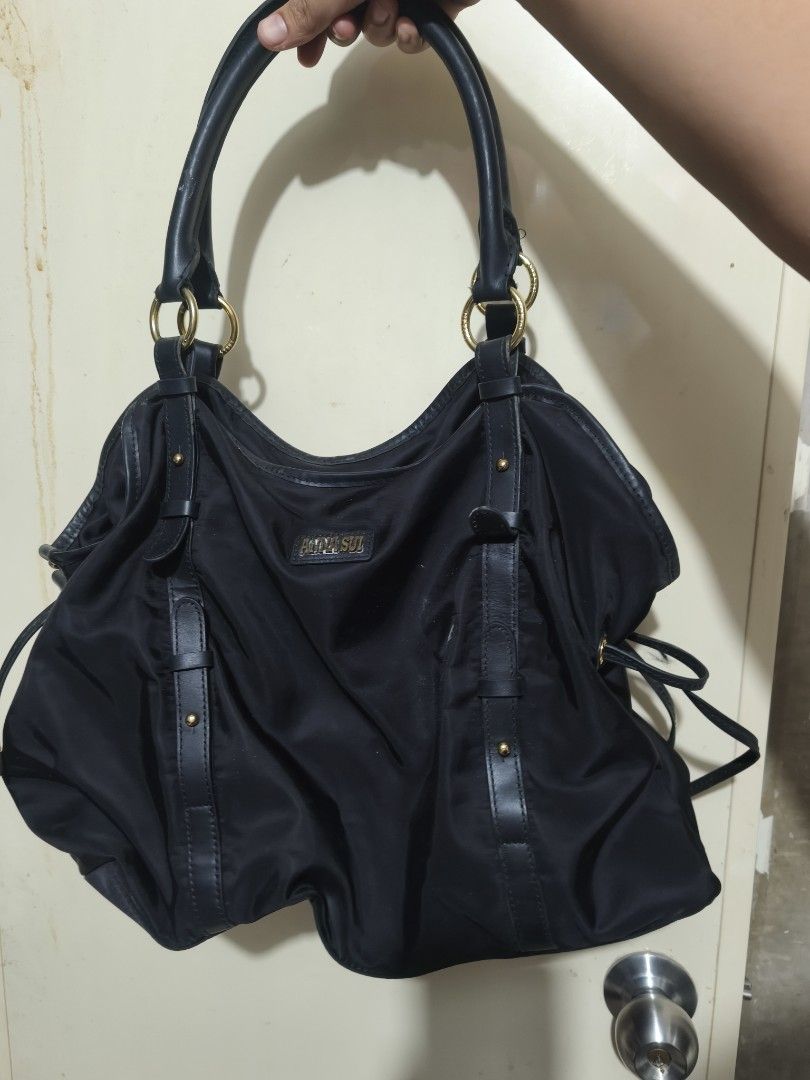 Anna Sui Black Nylon Leather Trim Shoulder Bag (Category: Shoulder Bags) located in Plaridel. Submitted by julleyuuuh (Listing ID 1463591775, Image 1). Description: - Brand: Anna Sui - Color: Black - Material: Nylon with leather trim - Hardware: Gold details - Interior: Purple floral lining - Closure: Top zipper - Features: Spacious, ideal for everyday use.