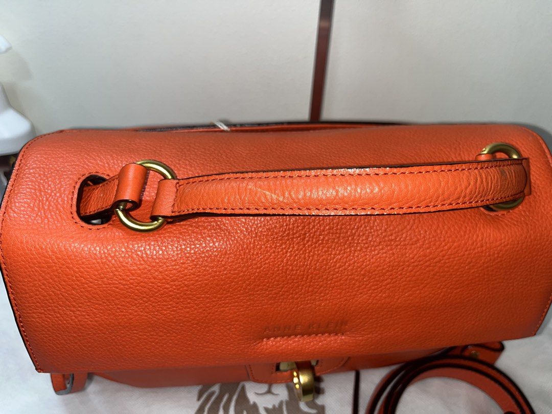 Anne Klein Orange Leather Top Handle Bag (Category: Luxury Bags & Wallets) located in Liloan. Submitted by sakurumifinds2809 (Listing ID 1463721847, Image 3). Description: - Authentic Anne Klein orange leather handbag - Features elegant gold hardware details - Secure twist lock closure - Comes with a detachable shoulder strap for versatile carrying - Includes original dust bag for protection - Ideal for everyday style and practicality.