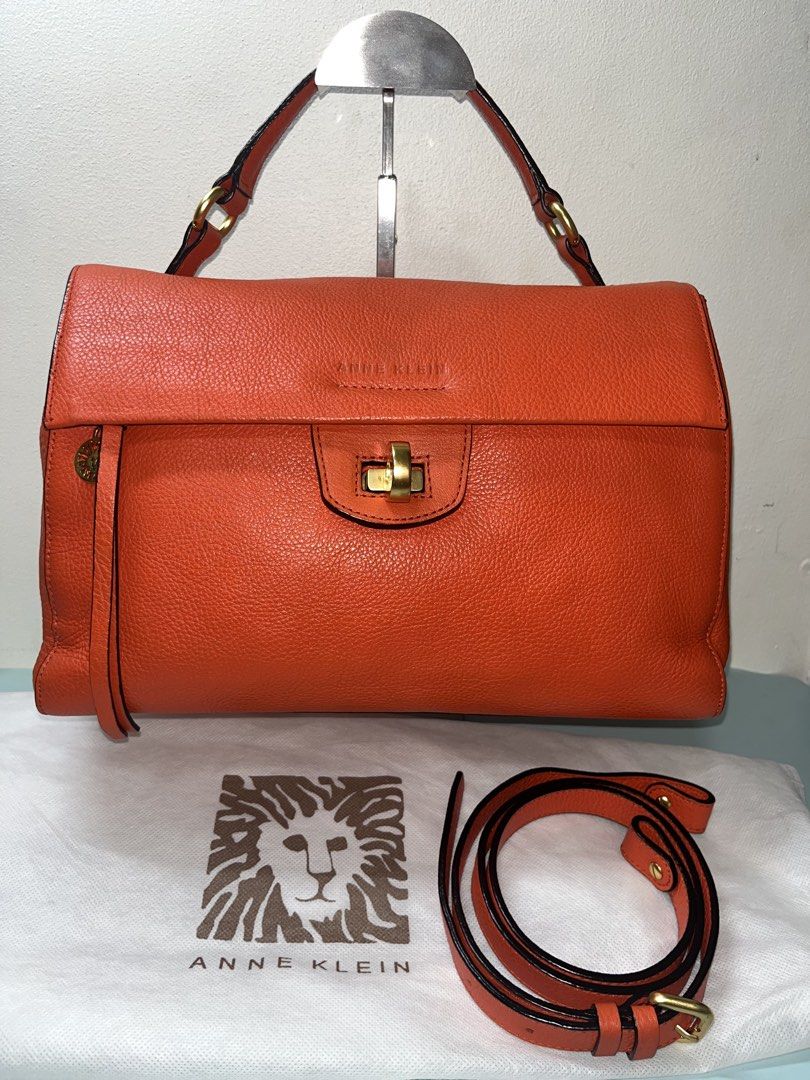 Anne Klein Orange Leather Top Handle Bag (Category: Luxury Bags & Wallets) located in Liloan. Submitted by sakurumifinds2809 (Listing ID 1463721847, Image 2). Description: - Authentic Anne Klein orange leather handbag - Features elegant gold hardware details - Secure twist lock closure - Comes with a detachable shoulder strap for versatile carrying - Includes original dust bag for protection - Ideal for everyday style and practicality.