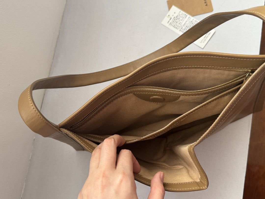 A.P.C. Ada Baguette Bag Tan Leather (Category: Shoulder Bags) located in Manila. Submitted by selenejuli94730 (Listing ID 1463620239, Image 2). Description: - Authentic A.P.C. shoulder bag - Color: Tan - Material: Genuine Leather - Interior: 1 zip pocket, 1 slip pocket - Comes with original tags - Ideal for everyday wear - Bought in Japan - Barely used.