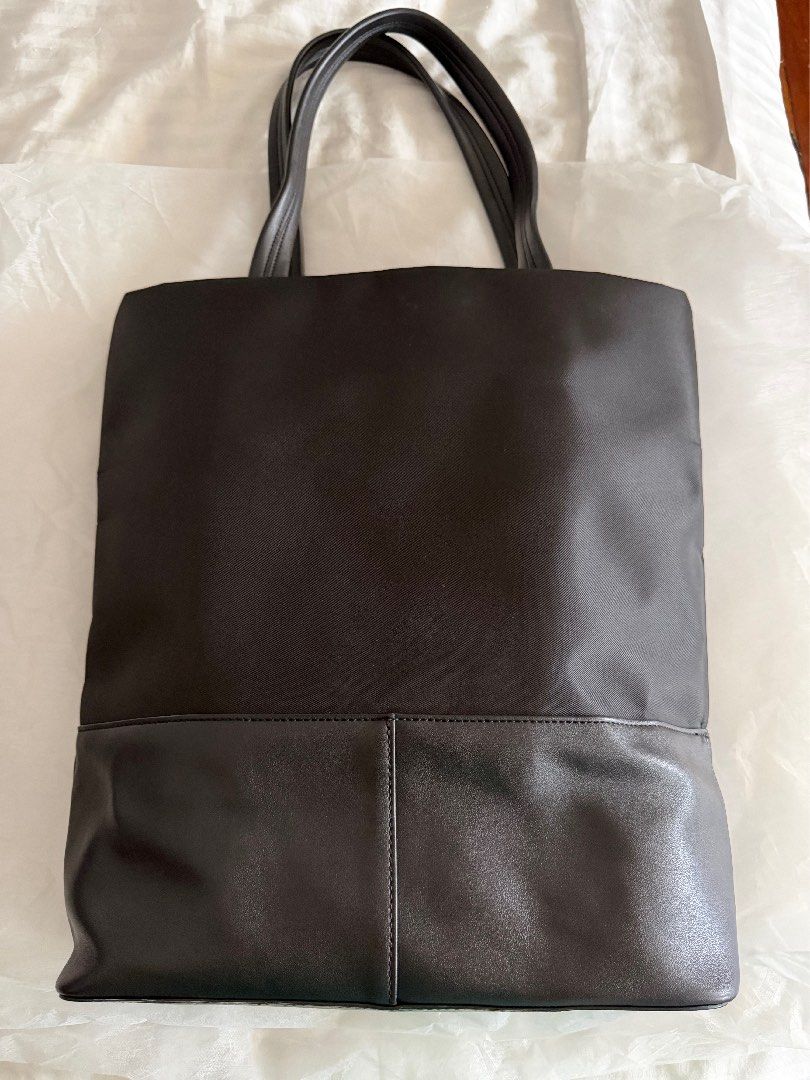 A.P.C. Camden Black Nylon Leather Tote Bag (Category: Tote Bags) located in Quezon City. Submitted by prettyme23 (Listing ID 1463619315, Image 2). Description: - Classic black tote bag from A.P.C. - Made with durable nylon and premium leather details - Simple, functional, and perfect for everyday use - Spacious interior for all your essentials - Subtle A.P.C. logo on the front - Comfortable handles for easy carrying.