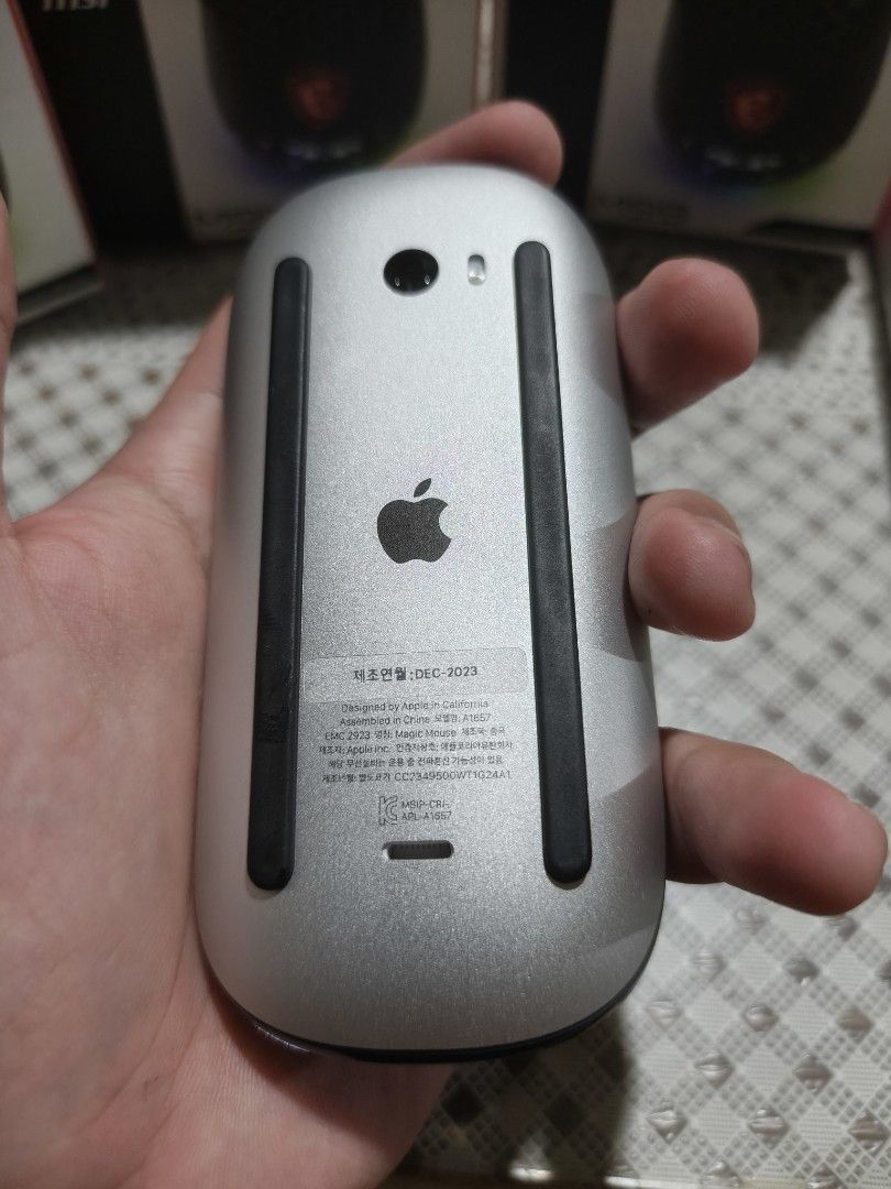Apple Magic Mouse 2 (nego) (Category: Mouse & Mousepads) located in Manila. Submitted by koro_mong (Listing ID 1463696026, Image 3). Description: - Apple Magic Mouse - Model: A1657 - Color: Black and Silver - Designed by Apple in California, Assembled in China - Manufactured: December 2023 - Condition:good as new now scratches - Cosmetic: Minor scuffs on black surface from normal use (please check photos for details).