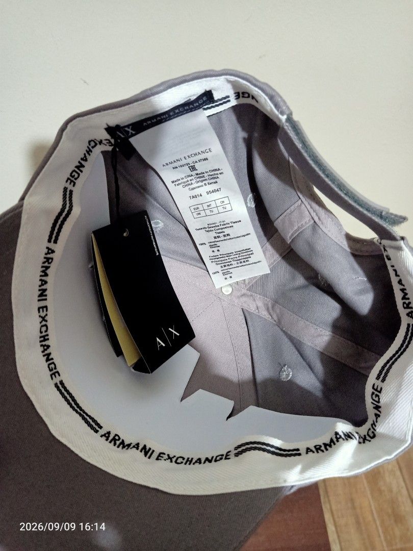 Armani Exchange AX Cap /Hat (Category: Caps & Hats) located in Las Pinas. Submitted by OmengSoyT (Listing ID 1463647915, Image 3). Description: - Authentic Armani Exchange cap -Grey color - Features iconic AX logo on the front - Adjustable rubber velcro strap for a custom fit - Comes with original hang and washed tags -One size fits all - Ideal for casual and everyday wear.