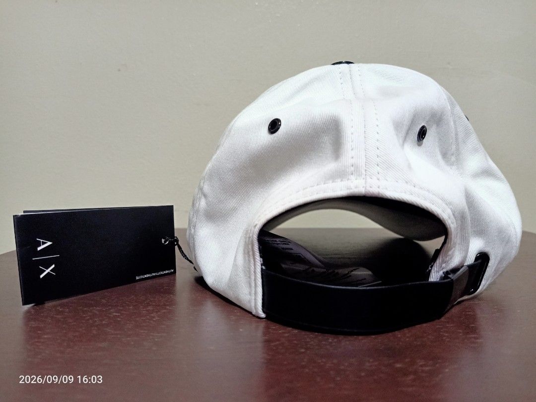 Armani Exchange AX White Cap/ Hat (Category: Caps & Hats) located in Las Pinas. Submitted by OmengSoyT (Listing ID 1463647062, Image 2). Description: -Authentic White Armani Exchange cap - Features the iconic AX logo on the front - Adjustable strap at the back for a customized fit - Comes with original hang and washed tags attached - Ideal for adding a stylish touch to casual outfit - One size fits all.
