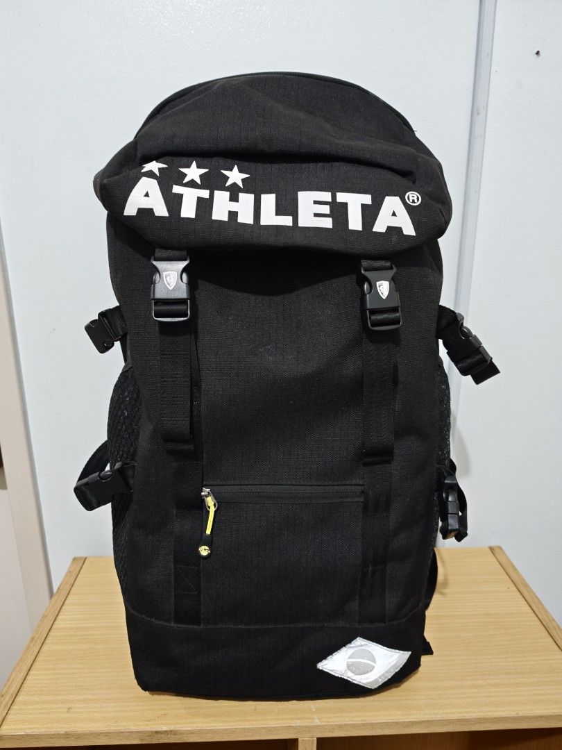 ATHLETA Black Backpack (Category: Backpacks) located in Manila. Submitted by liamsureplus.1995 (Listing ID 1463614723, Image 1). Description: - Black Athleta backpack - Features iconic Athleta logo with three stars on the front flap - Zippered pocket on the front for secure storage - Convenient side mesh pockets for water bottles or essentials - Adjustable straps for a comfortable fit - Ideal for everyday use, school, or travel adventures.