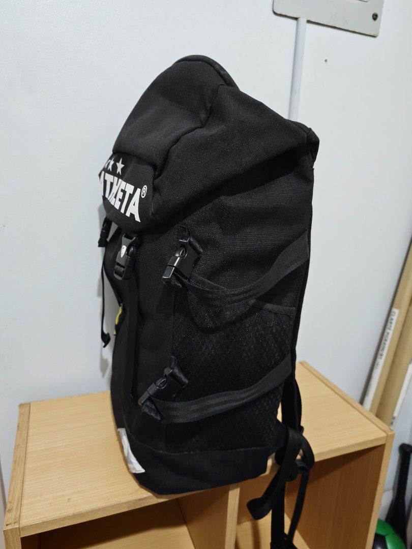 ATHLETA Black Backpack (Category: Backpacks) located in Manila. Submitted by liamsureplus.1995 (Listing ID 1463614723, Image 3). Description: - Black Athleta backpack - Features iconic Athleta logo with three stars on the front flap - Zippered pocket on the front for secure storage - Convenient side mesh pockets for water bottles or essentials - Adjustable straps for a comfortable fit - Ideal for everyday use, school, or travel adventures.