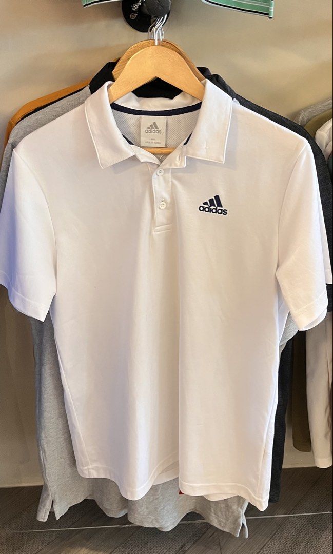 Authentic Adidas Men's Performance Polo Shirt – White (Category: Activewear) located in Dinalupihan. Submitted by banditvaultco (Listing ID 1463606668, Image 1). Description: Brand: Adidas Original / Performance Color: Pure White with black heat-transfer logo Size: Medium Excellent Condition Features:Lightweight, breathable, and moisture-wicking fabric—perfect for sports, golf, tennis, or everyday casual wear. Back features a cooling mesh panel c