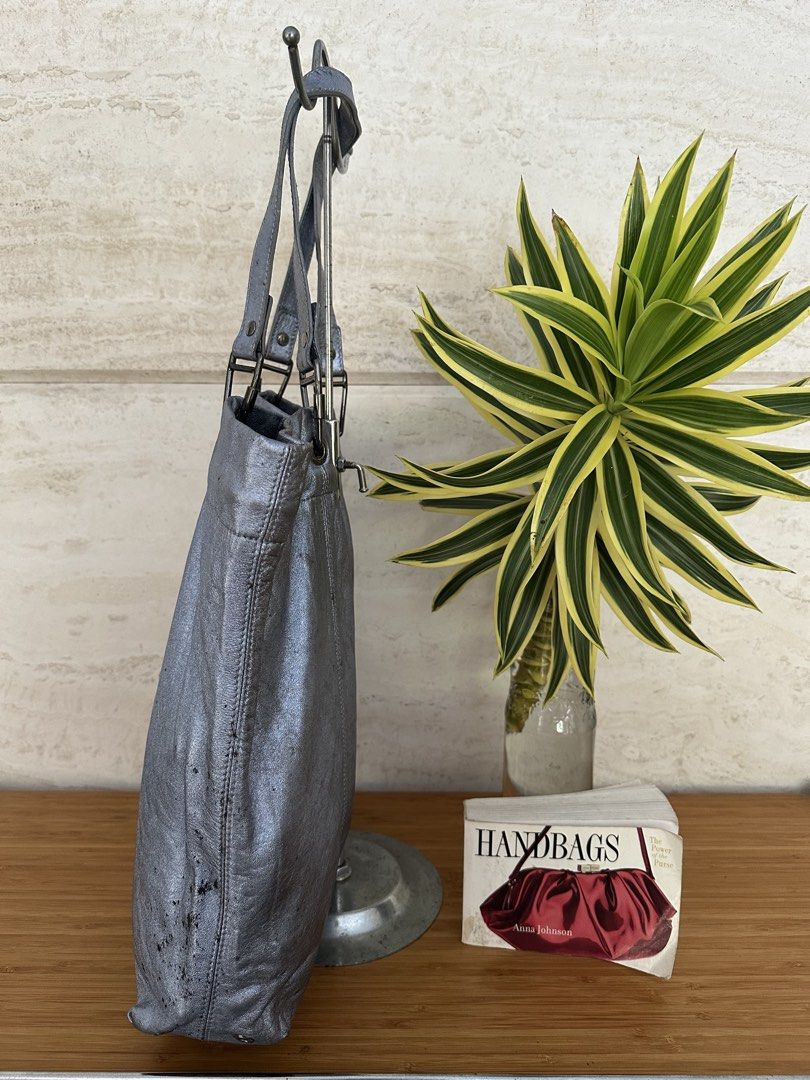 Authentic Burberry Leather Tote Bag - Silver Metallic (Category: Tote Bags) located in Muntinlupa City. Submitted by belica (Listing ID 1463581868, Image 2). Description: - Stylish silver metallic leather tote bag - Features the iconic Burberry Equestrian Knight logo - Spacious interior to hold all your essentials - Comfortable double shoulder straps for easy carrying - Minor signs of wear on bottom corners and exterior - Ideal for everyday use.