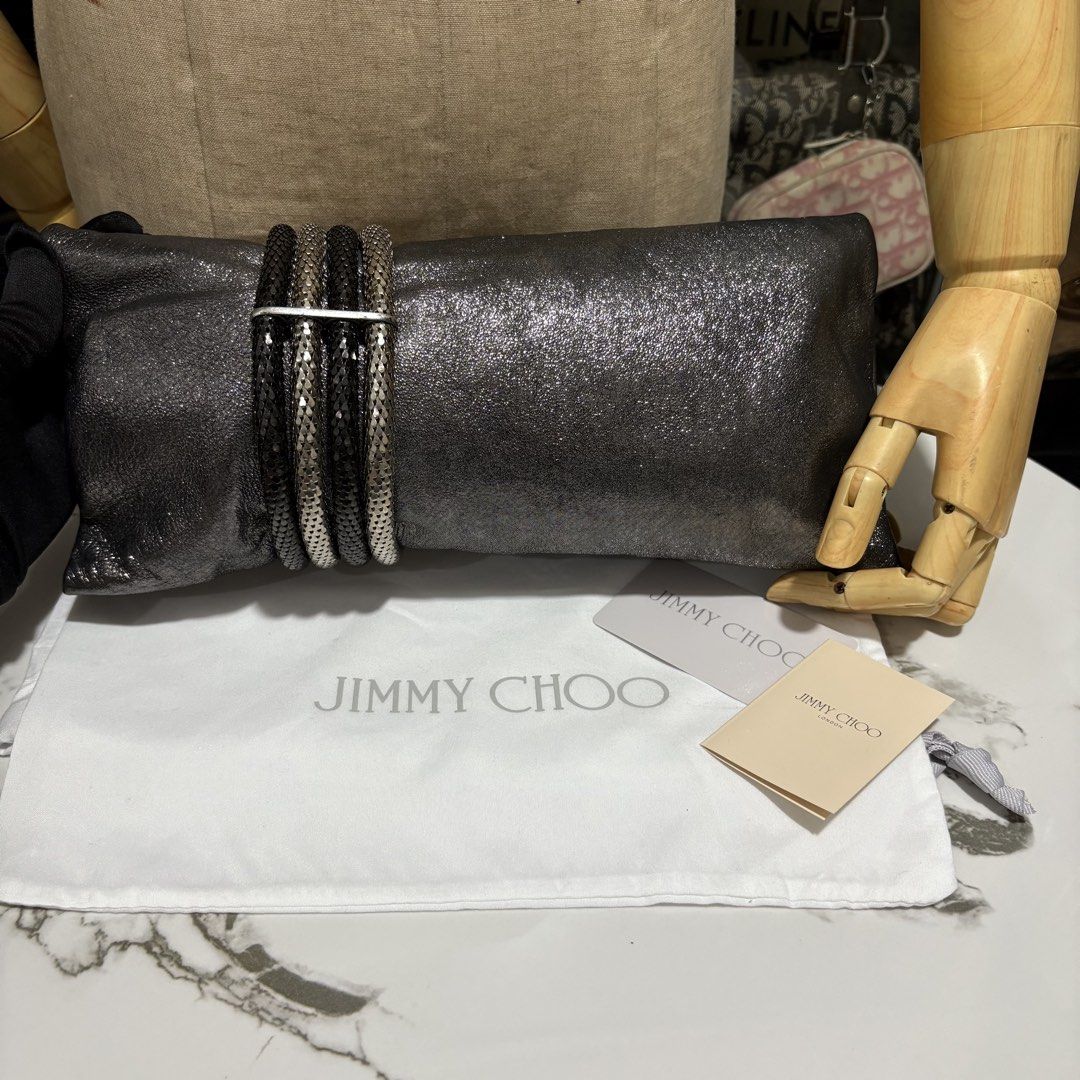 Authentic Jimmy Choo Chandra Metallic Silver Clutch Bag (Category: Clutches) located in Binangonan. Submitted by makoleksyon (Listing ID 1463671016, Image 3). Description: The main event on this clutch is obviously the banded metal closure, though, and I absolutely love it. The off-center placement is perfect, as is the decision to use two different colors of silver in order to set it apart from the finish of the clutch. In fact, I love it so muc