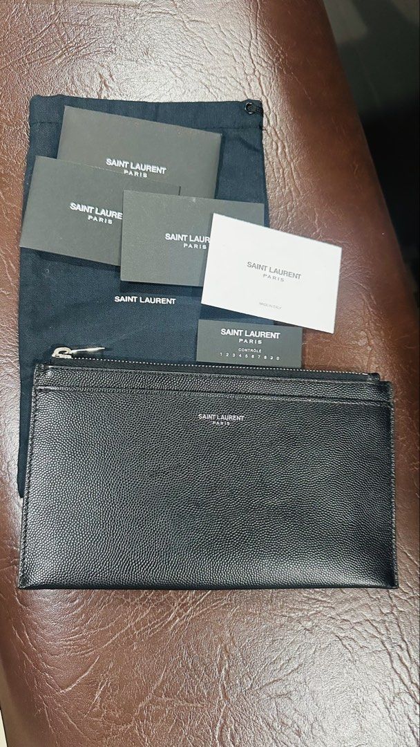 Authentic YSL Grain Leather Pouch (Category: Luxury Bags & Wallets) located in Las Pinas. Submitted by marshmallowmax (Listing ID 1463604890, Image 1). Description: Guaranteed Authentic! Like new or 9/0 condition. L-8 x H-4.5” With dustbag and cards.