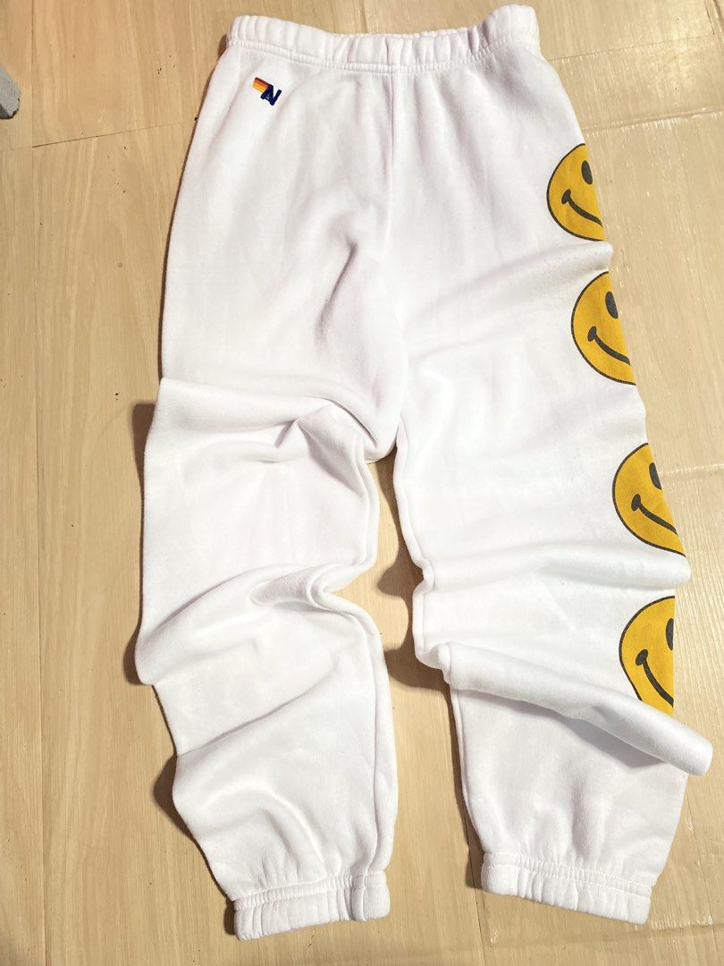 Aviator Nation White Smiley Face Sweatpants (Category: Joggers) located in Baguio. Submitted by workwear2600 (Listing ID 1463706917, Image 3). Description: - White Aviator Nation sweatpants - Fun smiley face detail down the side - Elastic waistband and cuffs for a comfortable fit - Super soft and cozy - Ideal for lounging or everyday casual wear -teens size fit 12 -like xs- small on adult -offer your price.