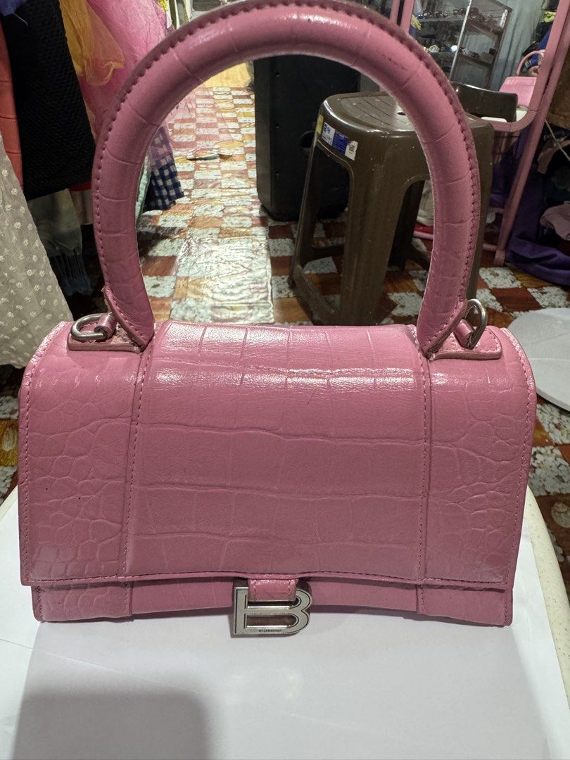 Balenciaga Original 100% (Category: Luxury Bags & Wallets) located in Manila. Submitted by wildbear.e10374 (Listing ID 1463640164, Image 1). Description: - Authentic Pink Balenciaga Hourglass Bag - Luxurious Croc Embossed Leather - Signature Silver 'B' Hardware Detail - Convenient Top Handle - Immaculate Interior - Like New! - Versatile: Perfect for Daily Errands or Glamorous Evenings - Elevate Any Outfit with This Chic Statement Piece.
