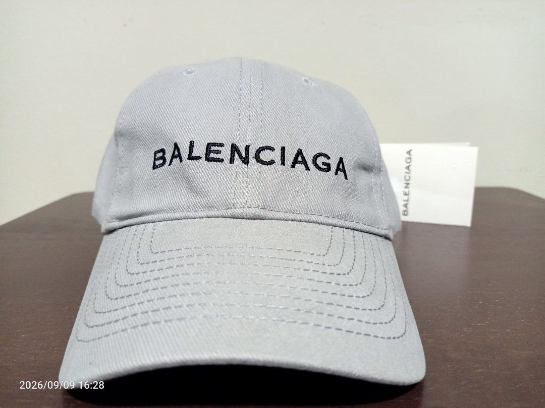Balenciaga Paris Cap (Category: Caps & Hats) located in Las Pinas. Submitted by OmengSoyT (Listing ID 1463649632, Image 2). Description: - Authentic Balenciaga cap - Color grey, 100% Cotton - One size fits all. Adjustable velcro strap - Features embroidered Balenciaga Paris logo on the front - Made in Italy - Comes with hang and washed tags - Ideal for everyday wear.
