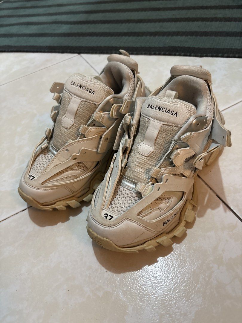 Balenciaga Track Sneakers Size 37 (Category: Sneakers) located in Quezon City. Submitted by shndm25 (Listing ID 1463707843, Image 1). Description: - Brand: Balenciaga - Model: Track Sneakers - Size: 37 - Color: Cream/Off-White - Style: Chunky Track - Condition: Missing right sole padding, and missing shoelaces. Can be replaced. Over all, it’s a 8/10. .