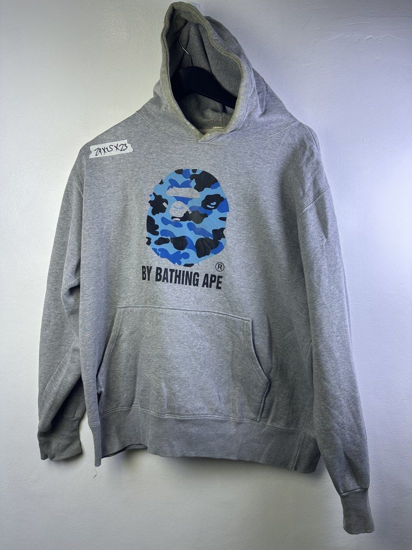 BAPE Blue Camo Shark Hoodie (Category: Hoodies) located in Manila. Submitted by declutterpromax (Listing ID 1463638508, Image 1). Description: - Iconic BAPE Blue Camo Shark graphic - 'BY BATHING APE' text below graphic - Front kangaroo pocket - Standard fit - Perfect for casual wear.