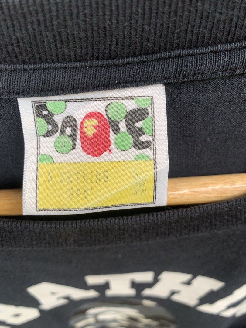 Bape college tee GITD (Category: Tshirts & Polo Shirts ) located in Aloran. Submitted by chester78864 (Listing ID 1463658078, Image 3). Description: - Classic black A Bathing Ape (BAPE) t-shirt - Features iconic camo ape head graphic on the front - BAPE logo arched above, 'APE' below the graphic - Small ape head tag detail on sleeve and hem - Made from 100% comfortable cotton - Ideal for any streetwear enthusiast.