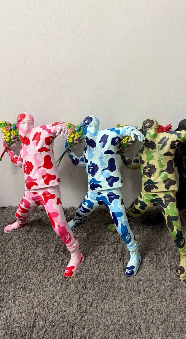 BAPE Inspired Camo Figurines with Flowers (Category: Figurines & Statues) located in Manila. Submitted by dreyaa22 (Listing ID 1463708614, Image 1). Description: - BAPE-inspired figurines - Available in pink, blue, and green camo patterns - Each figure holds a bouquet of flowers - Ideal for collectors and display - Eye-catching and conversation starter.