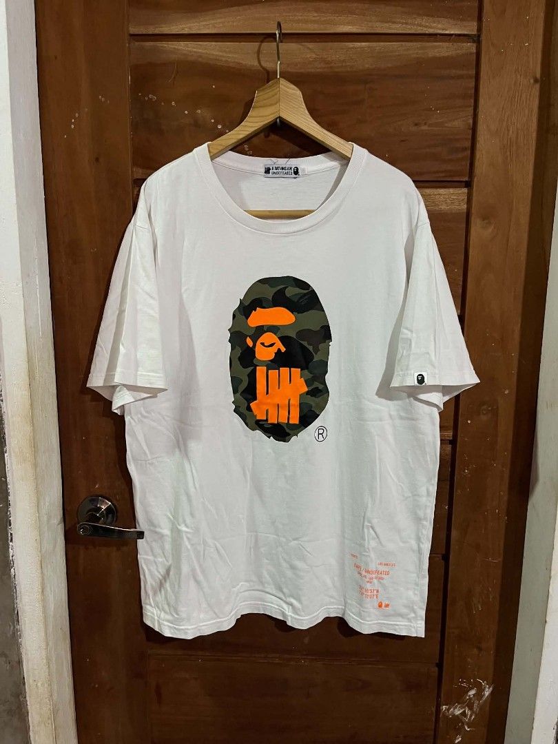 BAPExUNDEFEATED TEE (Category: Activewear) located in Tagum. Submitted by danelle_closet1106 (Listing ID 1463650477, Image 1). Description: EXCELLENT SIZE:XL TO XXL ISSUE:HAIRLINE SA PRINT SEE LAST PIC.