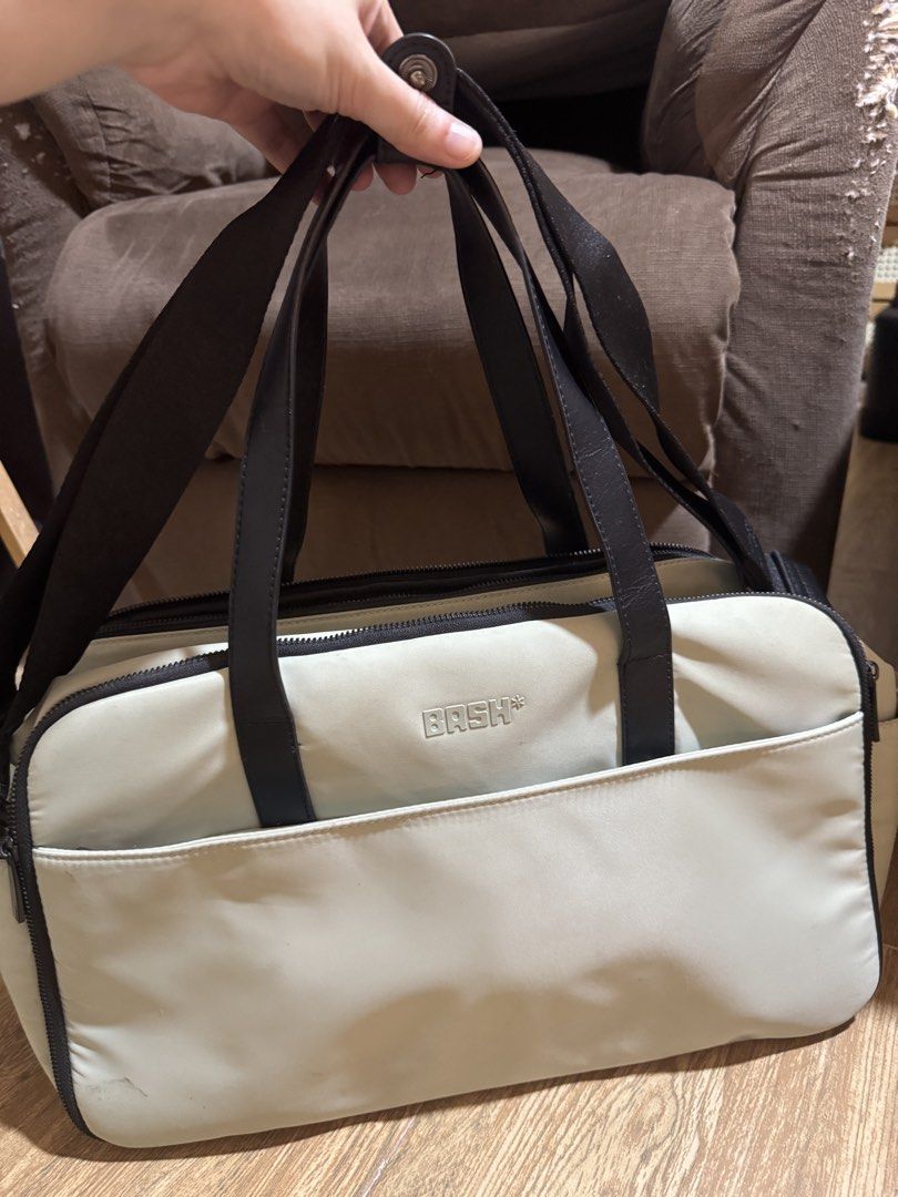BASH Duffel Bag (Category: Sling Bags) located in Las Pinas. Submitted by anjpgarcia (Listing ID 1463675194, Image 1). Description: - 1 light green colored duffel bag - 1 cream colored duffel bag - Black straps - Front pocket for easy access - Zippered compartment for secure storage - Embossed BASH logo on the front - Ideal size for weekend getaways or gym sessions - Smooth working zippers - Clean interior and exterior.