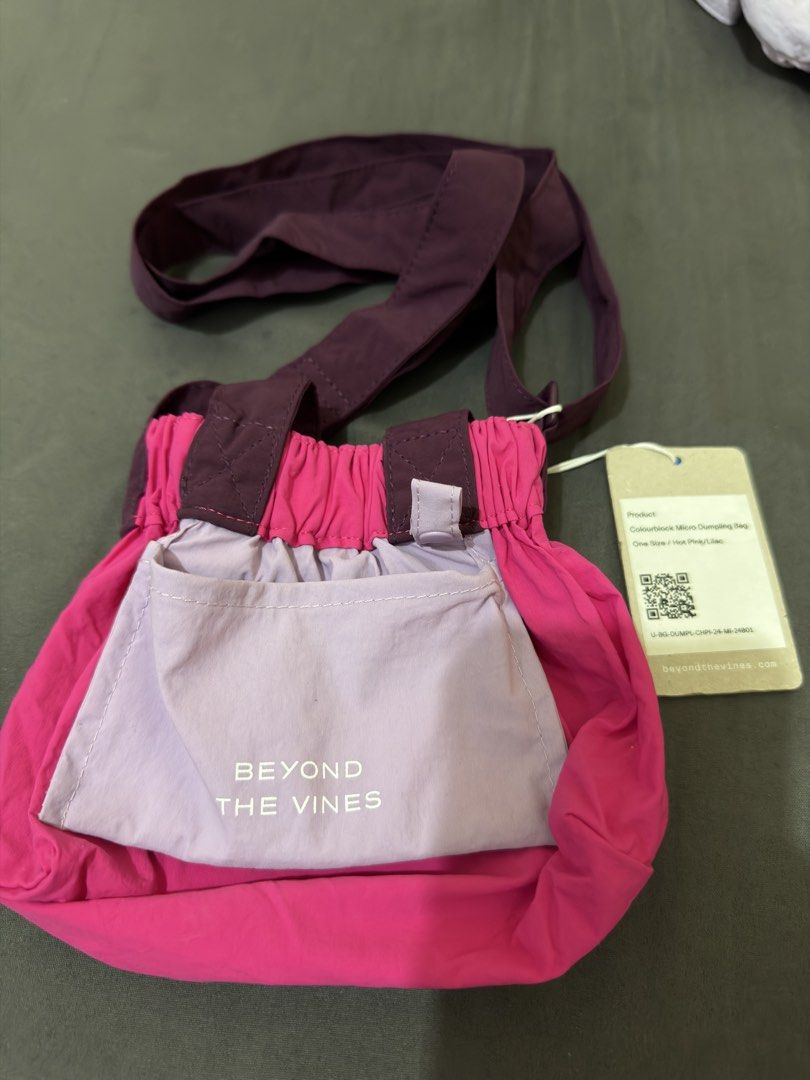 Beyond The Vines Colourblock Micro Dumpling Bag Hot Pink/Lilac (Category: Cross-body Bags) located in Calamba. Submitted by nes_936 (Listing ID 1463672392, Image 1). Description: - Brand: Beyond The Vines - Model: Colourblock Micro Dumpling Bag - Colorway: Hot Pink and Lilac - Size: One Size - Features: Adjustable strap with buckle, elasticated top opening, snap button closure on sides - Condition: Brand new with tags.