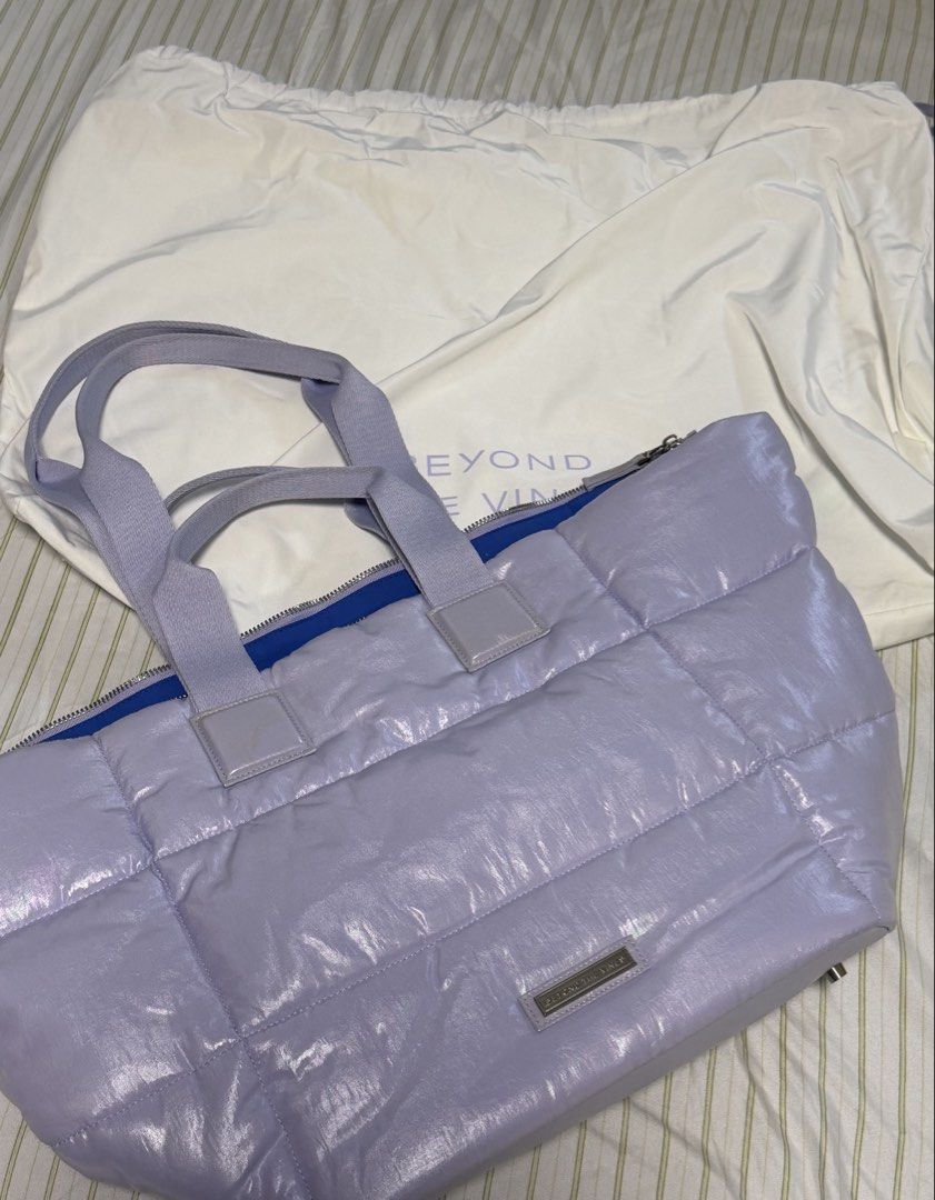 Beyond The Vines Puffer Tote Bag - Lilac (Category: Tote Bags) located in Manila. Submitted by amandada.doo (Listing ID 1463667737, Image 2). Description: - Lilac puffer tote bag from Beyond The Vines -Never been used - Shiny, quilted material - Zipper closure - Bright blue interior lining - Small interior pocket - Comes with a dust bag - Ideal for everyday use or travel.