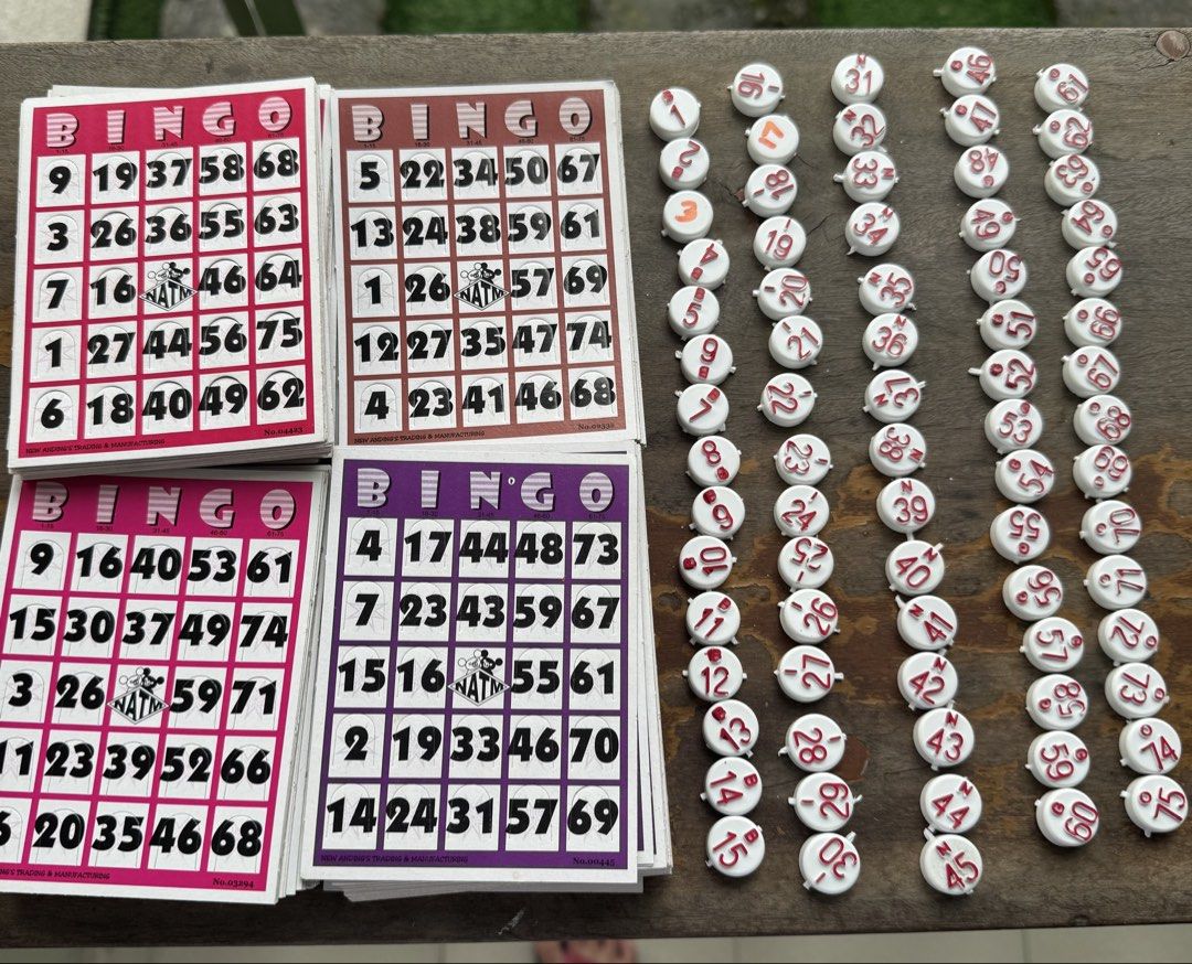 Bingo Cards and Numbered Tokens Set (Category: Board Games & Puzzles) located in Manila. Submitted by xenasales (Listing ID 1463642451, Image 1). Description: - Complete Bingo Game Set - Includes multiple decks of bingo cards in various colors: pink, brown, purple, and another pink deck. - Comes with a collection of white tokens featuring red numbers. - Ideal for hosting parties or enjoying family game nights. - Everything you need for a fun-fill