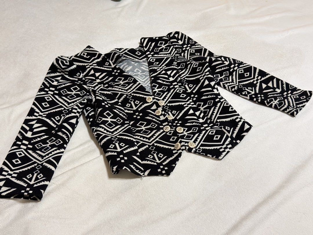 Black and White Geometric Print Blazer (Category: Coats, Jackets and Outerwear) located in Cebu City. Submitted by eynjlin (Listing ID 1463691773, Image 2). Description: - Eye-catching black and white geometric print blazer - Unique, bold design - Features elegant gold-toned buttons on the front - Versatile for layering over tops or dresses - Adds a stylish statement to any outfit.