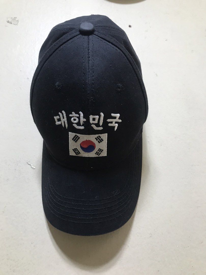 Black Baseball Cap with South Korea Flag and Text (Category: Caps & Hats) located in Baguio. Submitted by kurtshelby (Listing ID 1463611855, Image 1). Description: - Classic black baseball cap - Features embroidered Korean text '대한민국' (Daehan Minguk) and South Korean flag on the front - Adjustable strap with a metal buckle for a secure fit - 'BLUE' label inside, indicating one size fits most - Ideal for expressing national pride or as a stylish e
