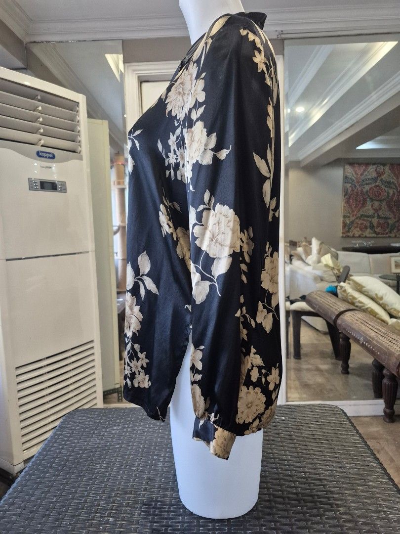 Black Floral 100% Silk Button-Up Blouse (Category: Blouses) located in Quezon City. Submitted by soaring7 (Listing ID 1463575944, Image 2). Description: - Beautiful black blouse with a cream and beige floral print. - Made of 100% luxurious silk. - Classic button-up front with a collared neckline. - Long sleeves with button cuffs for a polished look. - Highly versatile - perfect for dressing up or down. - Flattering fit that looks really nice on..