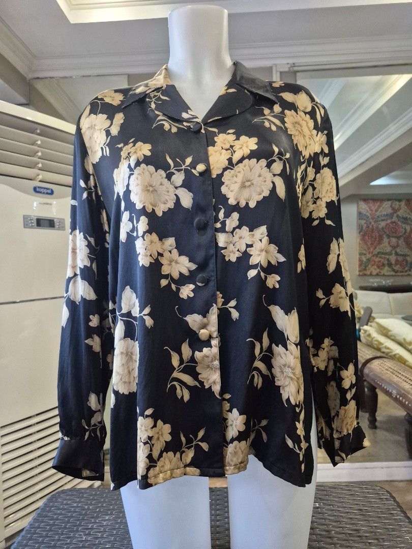 Black Floral 100% Silk Button-Up Blouse (Category: Blouses) located in Quezon City. Submitted by soaring7 (Listing ID 1463575944, Image 1). Description: - Beautiful black blouse with a cream and beige floral print. - Made of 100% luxurious silk. - Classic button-up front with a collared neckline. - Long sleeves with button cuffs for a polished look. - Highly versatile - perfect for dressing up or down. - Flattering fit that looks really nice on..