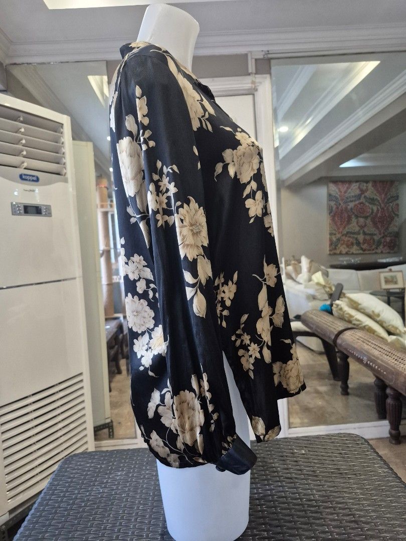 Black Floral 100% Silk Button-Up Blouse (Category: Blouses) located in Quezon City. Submitted by soaring7 (Listing ID 1463575944, Image 3). Description: - Beautiful black blouse with a cream and beige floral print. - Made of 100% luxurious silk. - Classic button-up front with a collared neckline. - Long sleeves with button cuffs for a polished look. - Highly versatile - perfect for dressing up or down. - Flattering fit that looks really nice on..